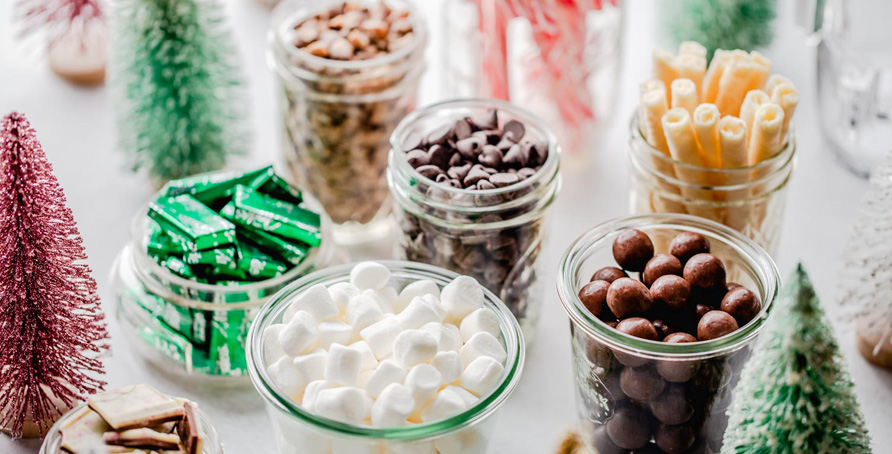 Holiday Hot Chocolate Bar bottle brush Christmas trees and jars of hot chocolate toppings