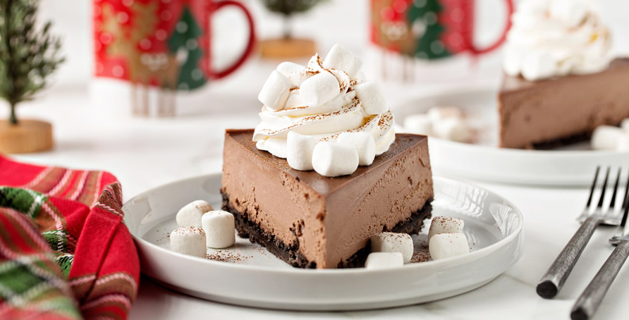 Hot Cocoa Cheesecake with whipped cream and mini marshmallows