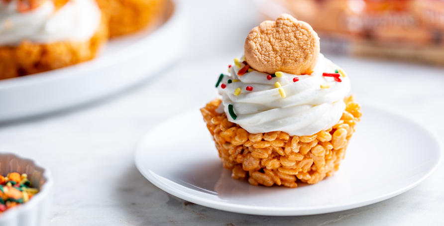cereal treat cupcake with frosting, pumpkin marshmallow, and sprinkles